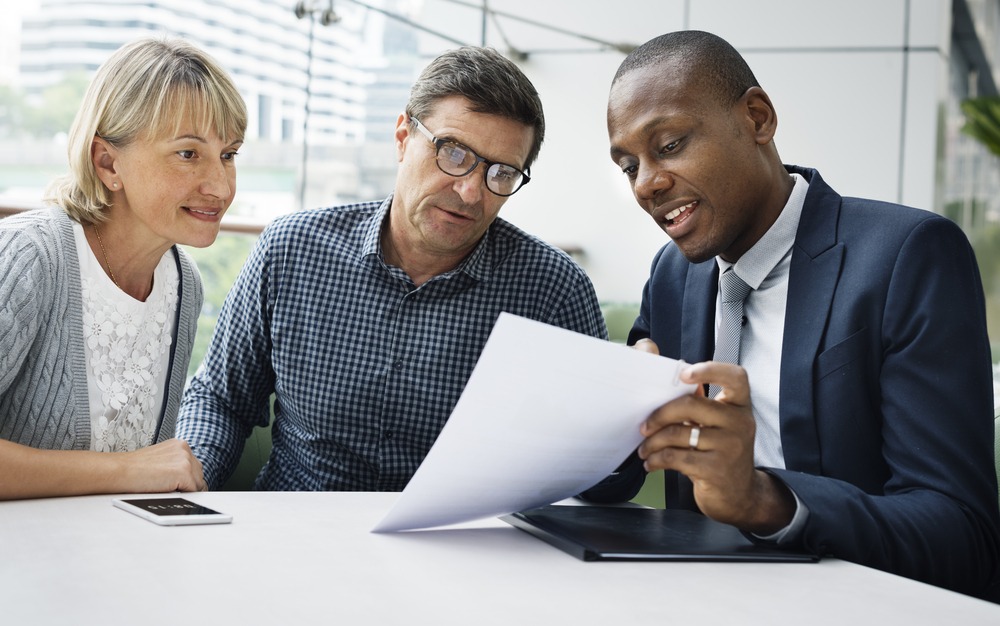 insurance agent going over paperwork with clients
