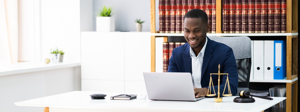 lawyer smiling while working at his desk