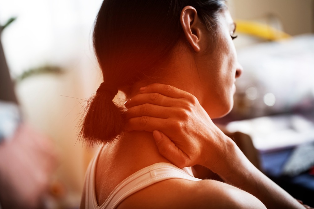 Back view of a woman with a neckache. How long should you be sore after a car accident?
