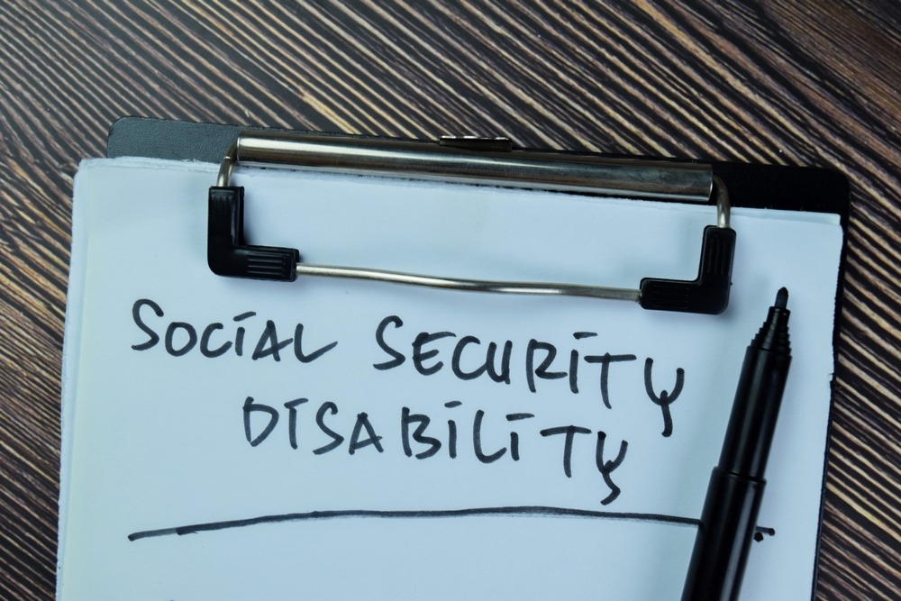 Piece of paper with “Social Security Disability Insurance” written on it, with someone nearby wondering how much is SSDI in South Carolina in 2026