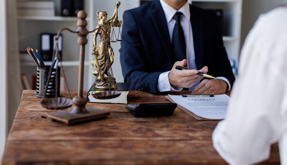 A person speaking to a lawyer in their office. Learn about what your rights are if your dog was attacked by another dog.