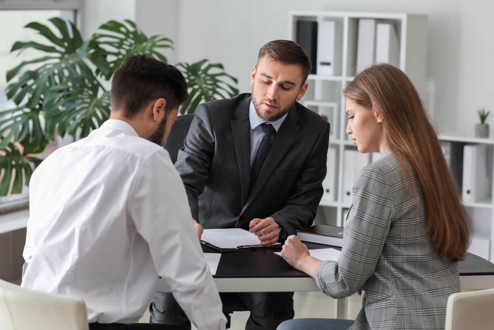 A family law attorney explains legal options to a couple during a divorce and custody consultation in North