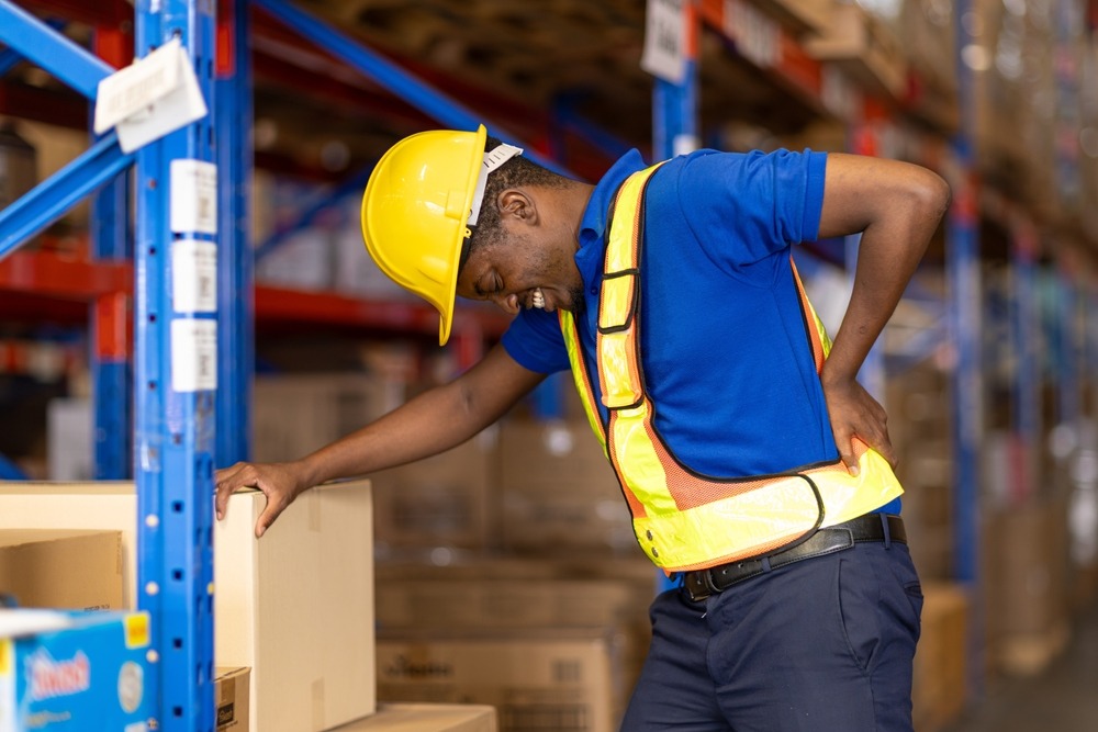 An injured construction worker holding his back. What is workers’ compensation?