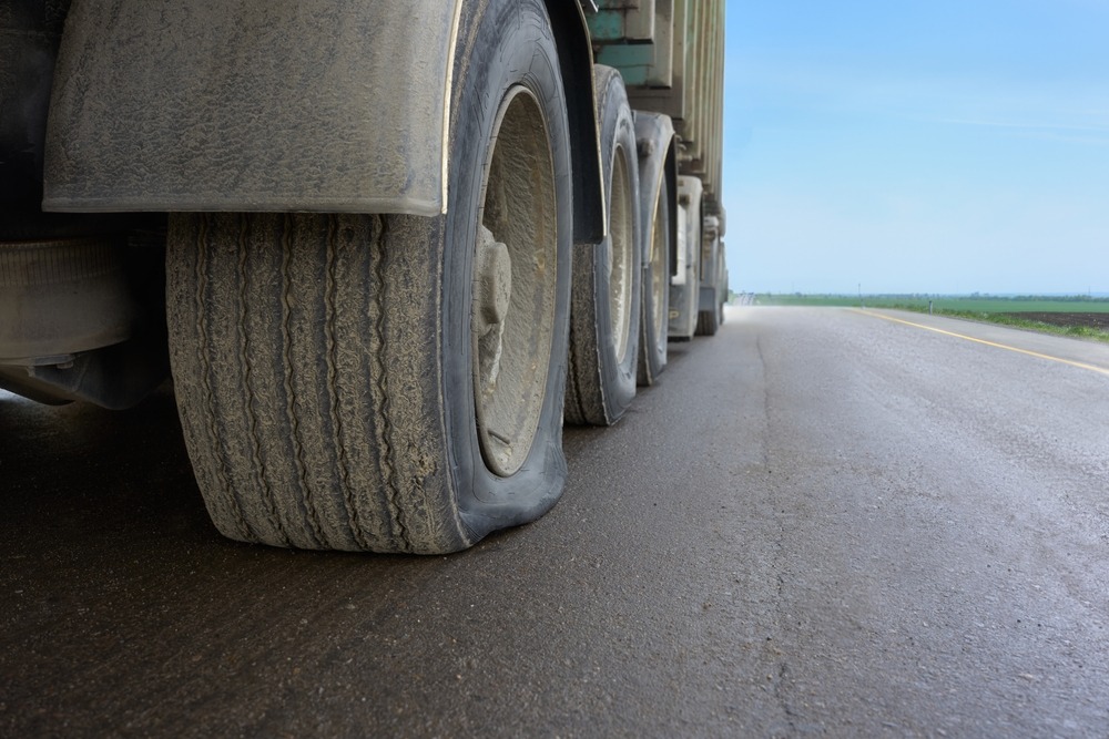 A truck broken down on the side of the road after an override or underride truck accident