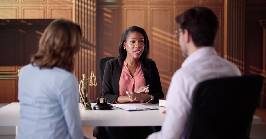 Lawyer meets with clients to explain what a divorce decree is.